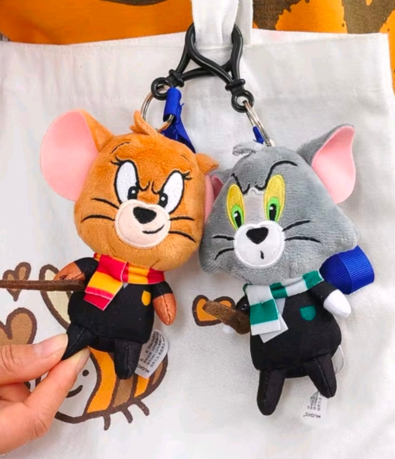 Wizard plush keychain set with orange and gray characters, hanging from metal hooks
