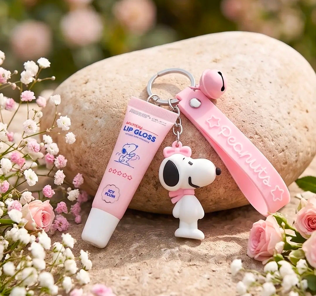 Peanuts-themed lip gloss keychain with Snoopy figure and pink wrist strap