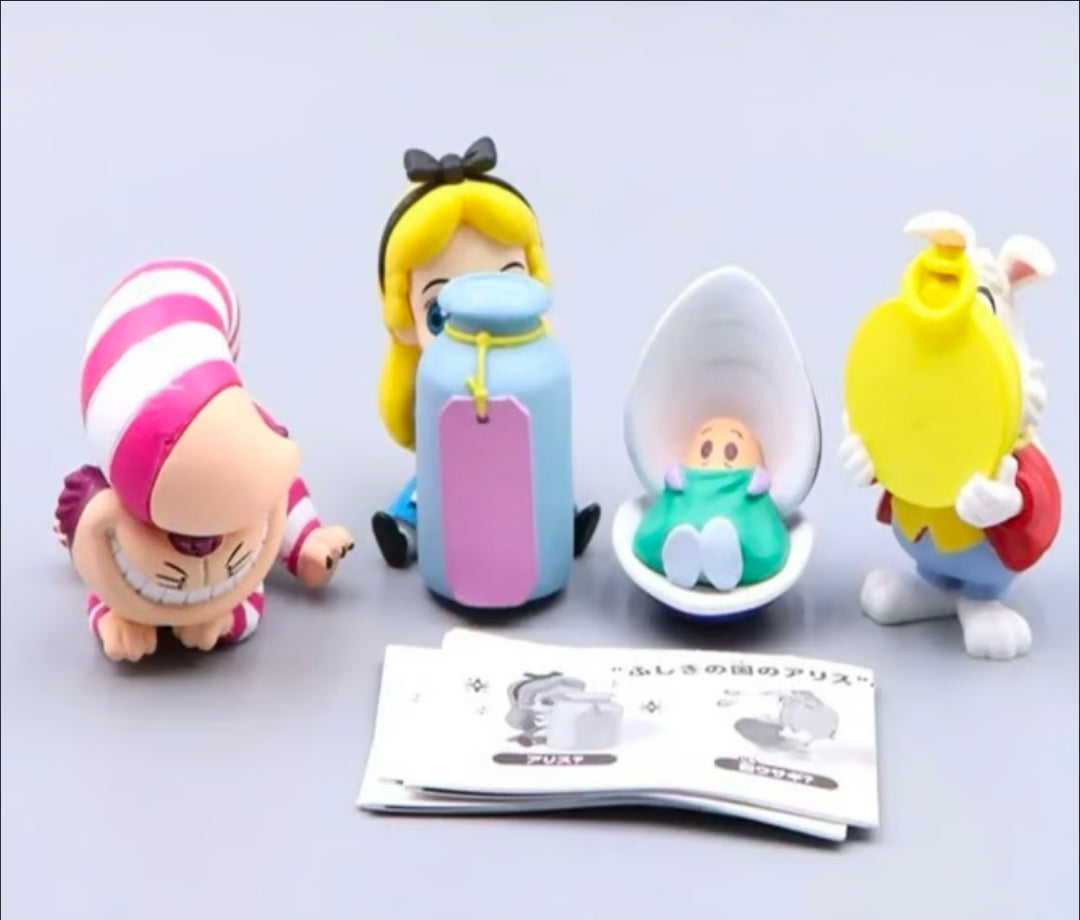 Set of four colorful chibi gashapon figures, including striped cat and rabbit