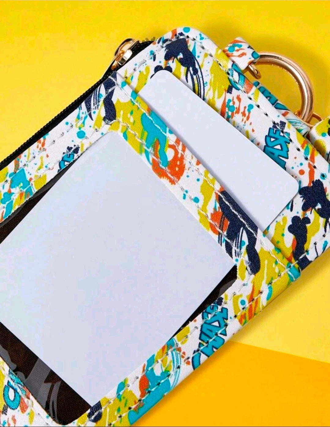 Zipper card holder keychain wallet with paint-splash print, open pocket view and black trim