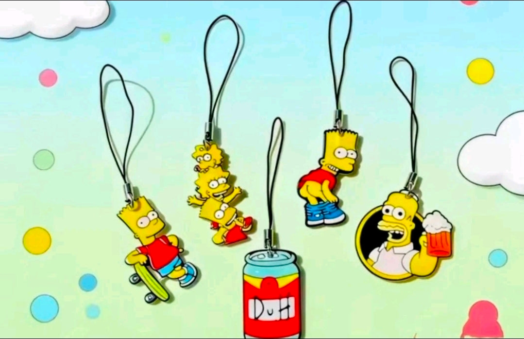 Five Simpsons character acrylic phone charms on black straps, spaced across the frame