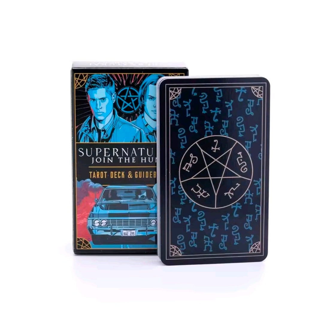 Tarot deck box and opened guidebook, blue artwork with car and two men
