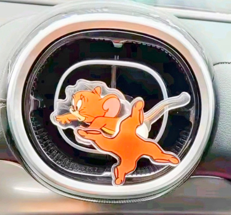Orange cartoon cat acrylic air-vent spinner clip with glowing white ring.