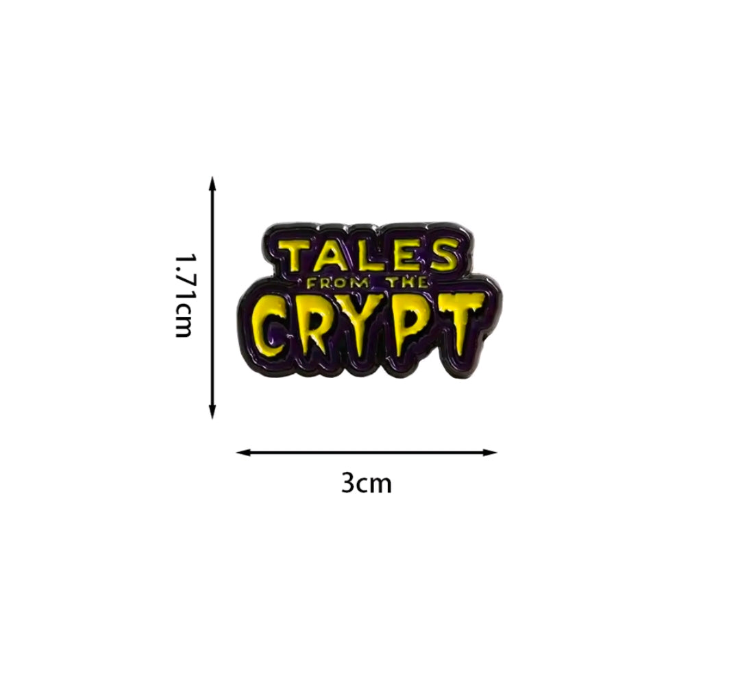 Tales from the Crypt enamel logo pin, black with yellow and purple lettering.