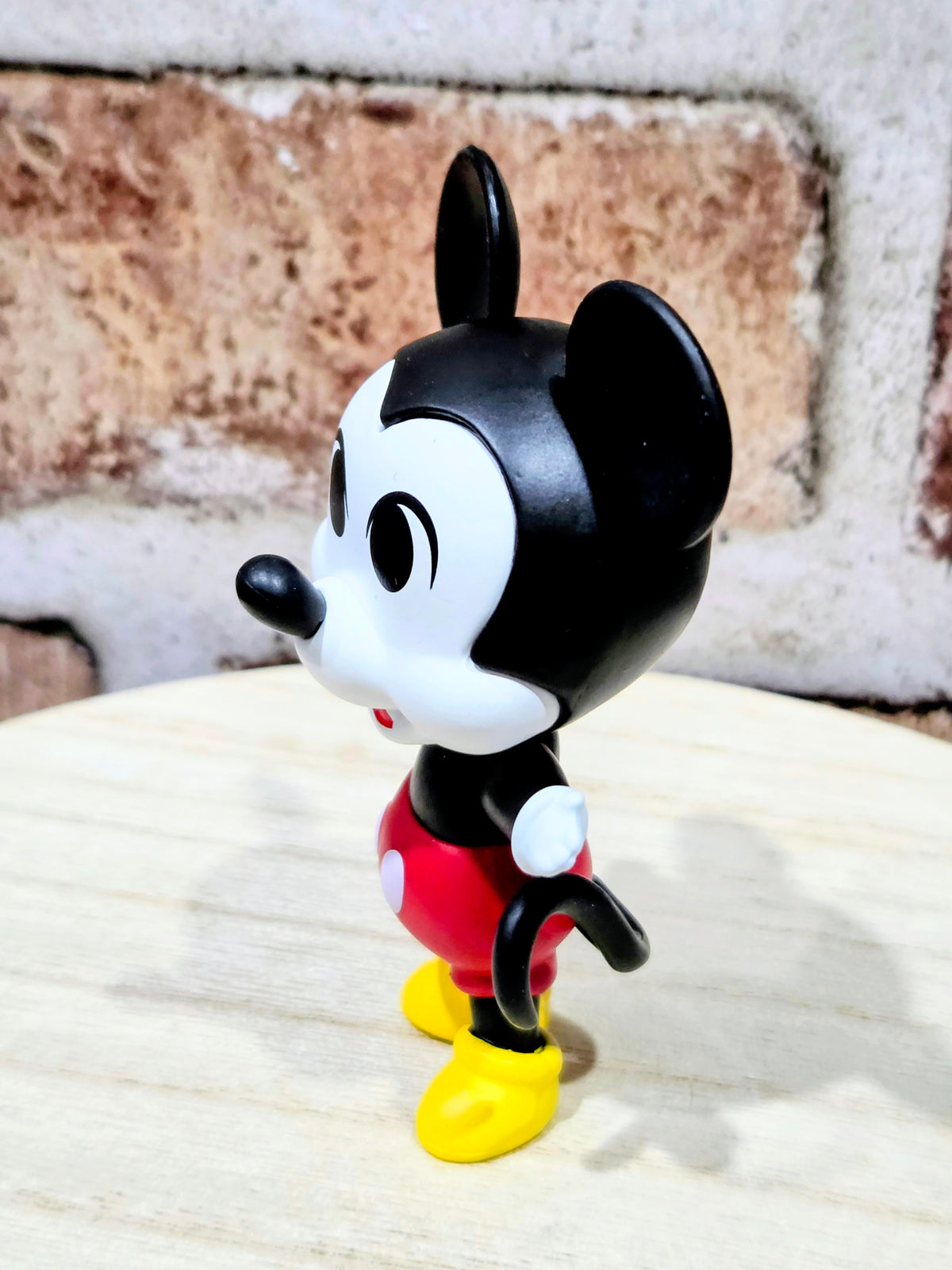 Mickey Mouse vinyl mystery mini figure, black ears, red shirt, yellow shoes.