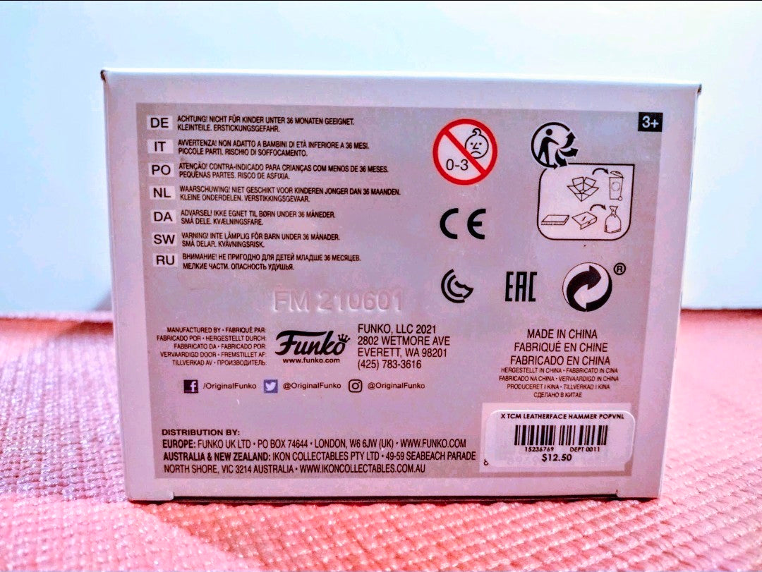 Vinyl figure box back with product details, icons, and warning symbols