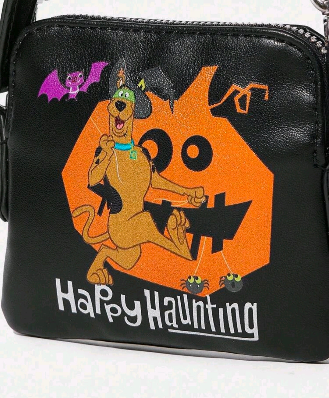 Black clutch with close-up Happy Haunting graphic of cartoon dog and orange haunted house
