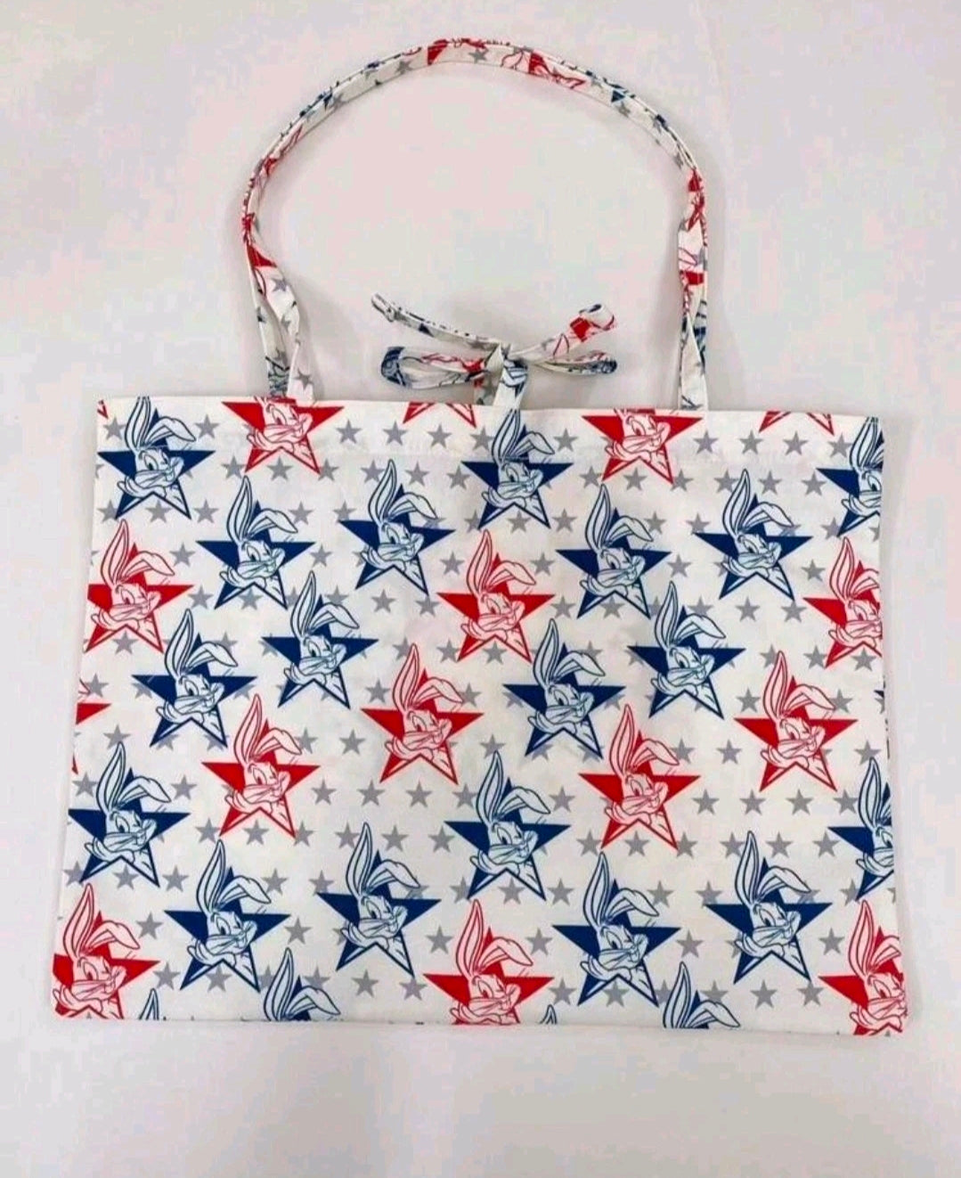 Patriotic tote bag with star and cartoon bunny graphics in red, white, and blue