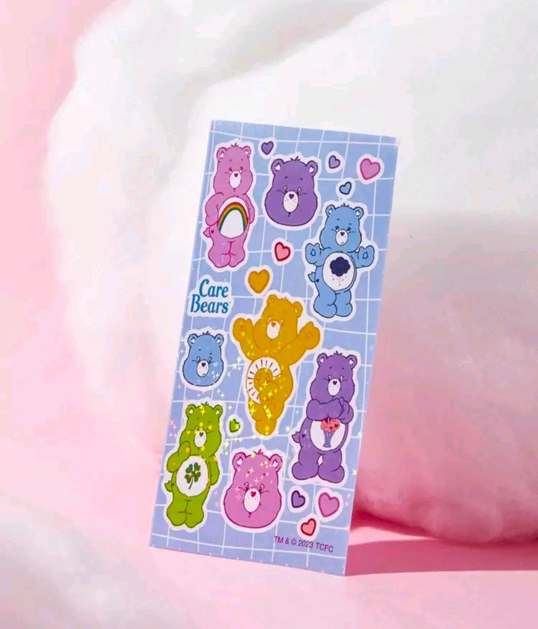 Holographic sticker sheet with Care Bears characters, hearts, and sparkle shapes