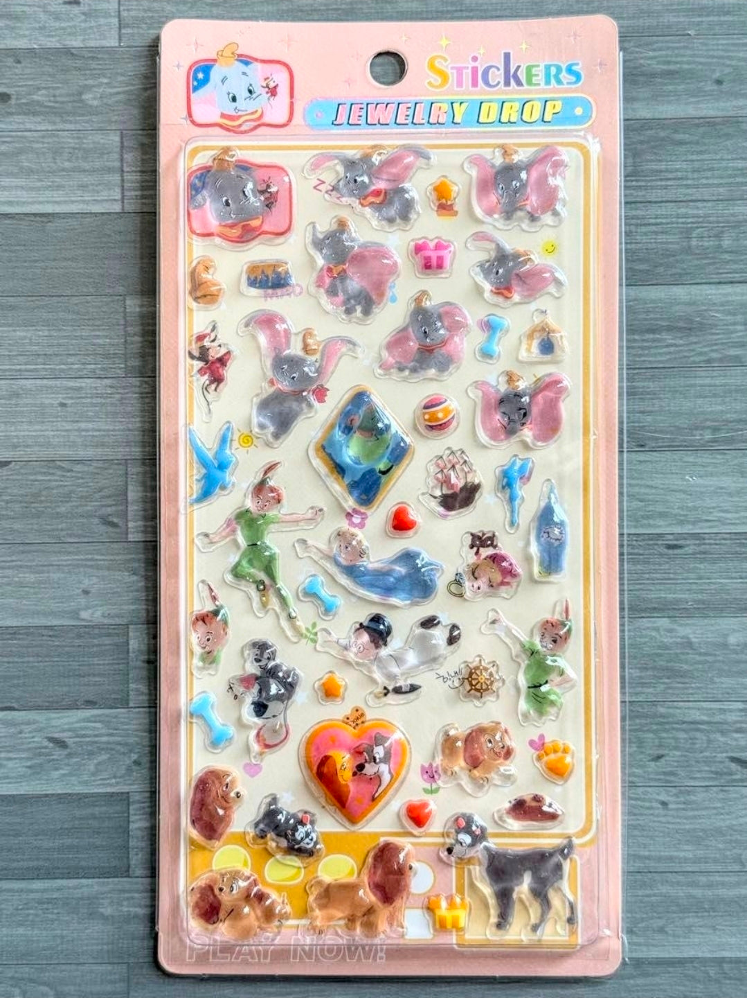Disney jewelry drop sticker sheet with assorted animal, heart, and color charms