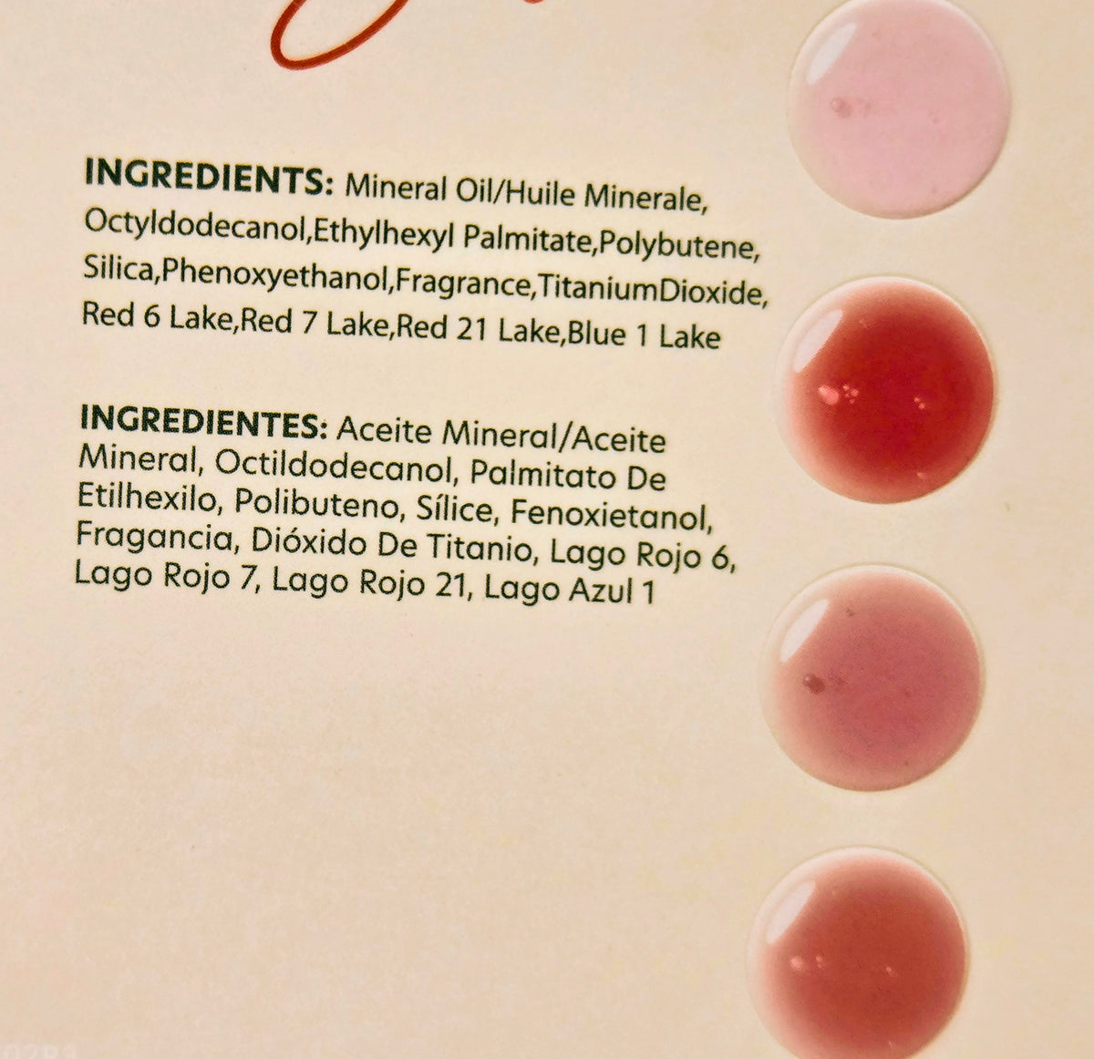 Fruit lip gloss set swatches on a light card, showing pink and red gloss tones