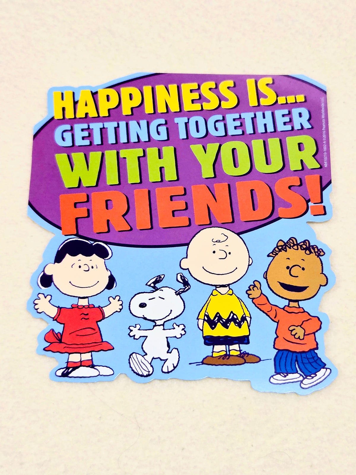 Purple Peanuts wall decor cutout with Snoopy and friends: "Happiness is... with your friends!"