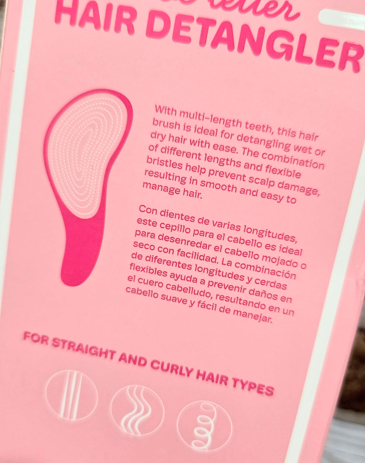 Pink hair detangler box insert with brush graphic and detangling directions