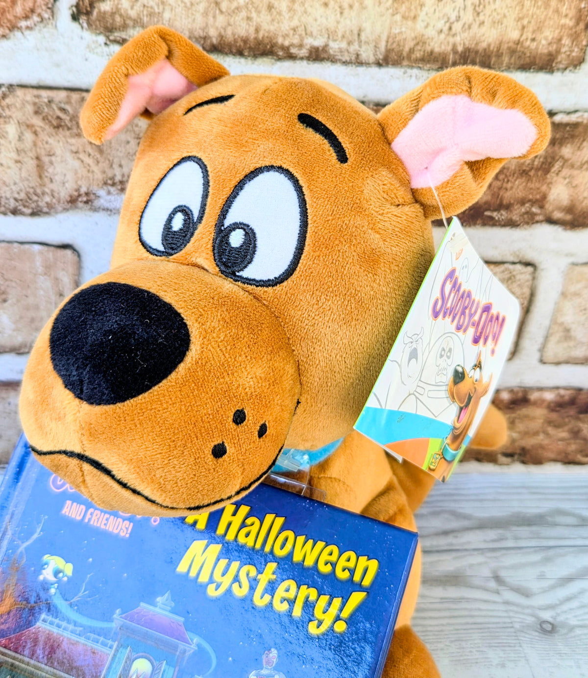 Orange Scooby-Doo plush holding a Halloween mystery hardcover book