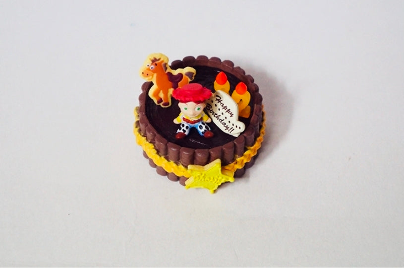Western birthday cake mini figure with 'Happy Birthday' topper and star decoration