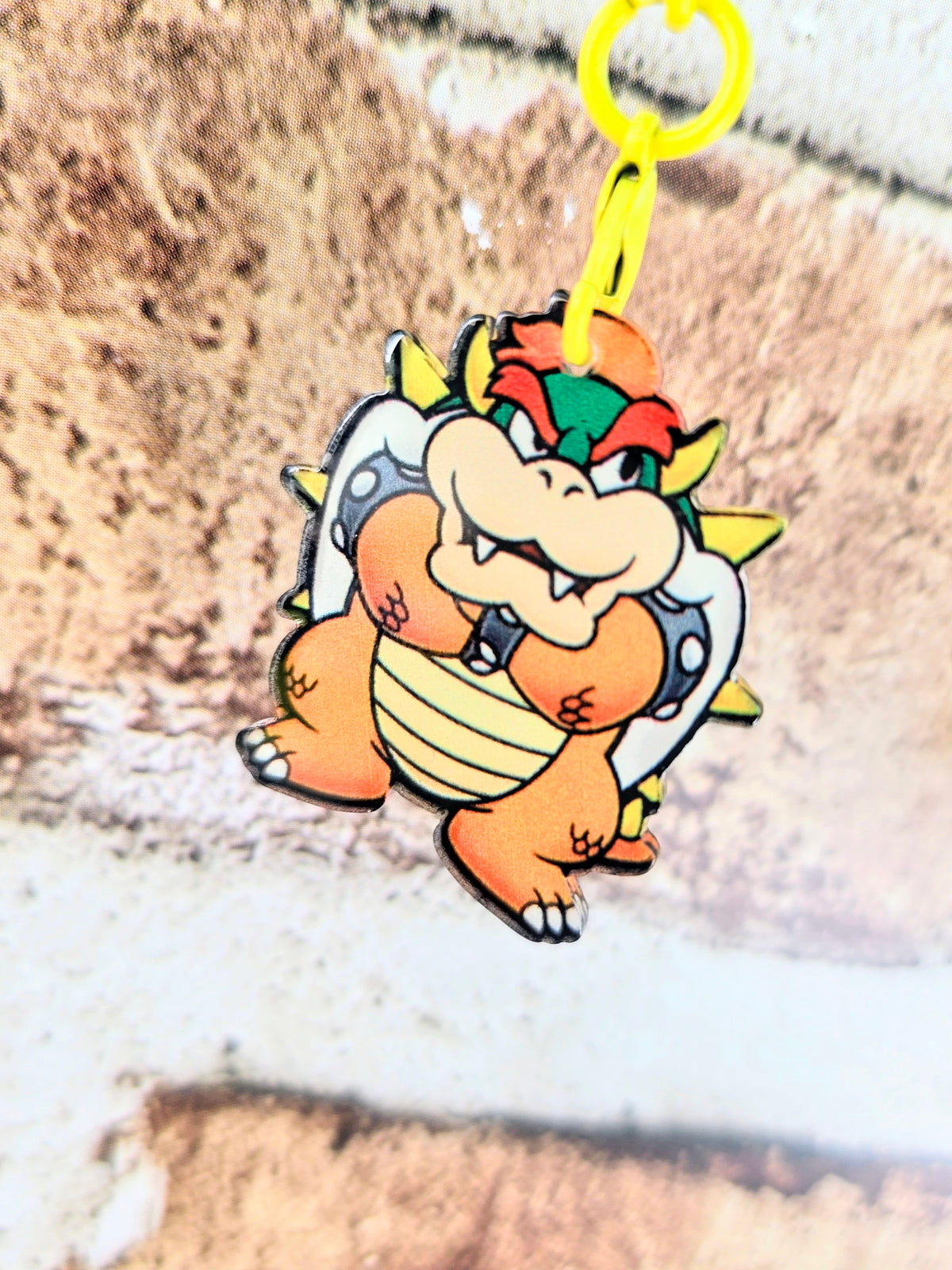 Bowser acrylic keychain with yellow ring, standing face-forward character