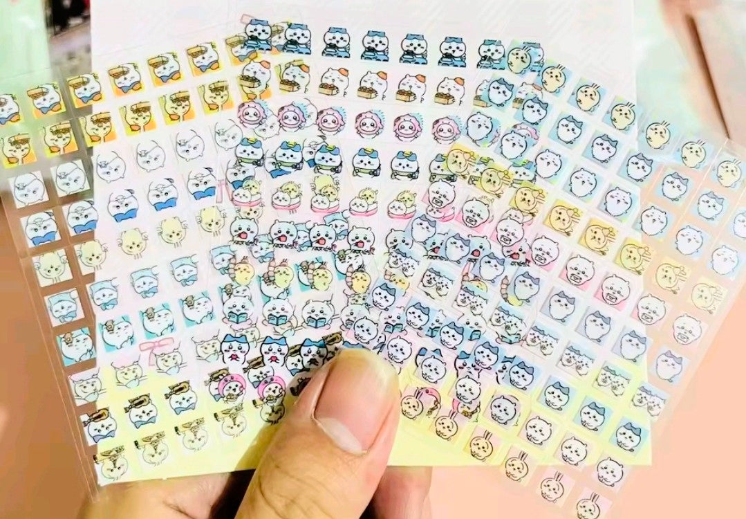 Clear-back sticker sheet with many small animal face stickers in pastel colors