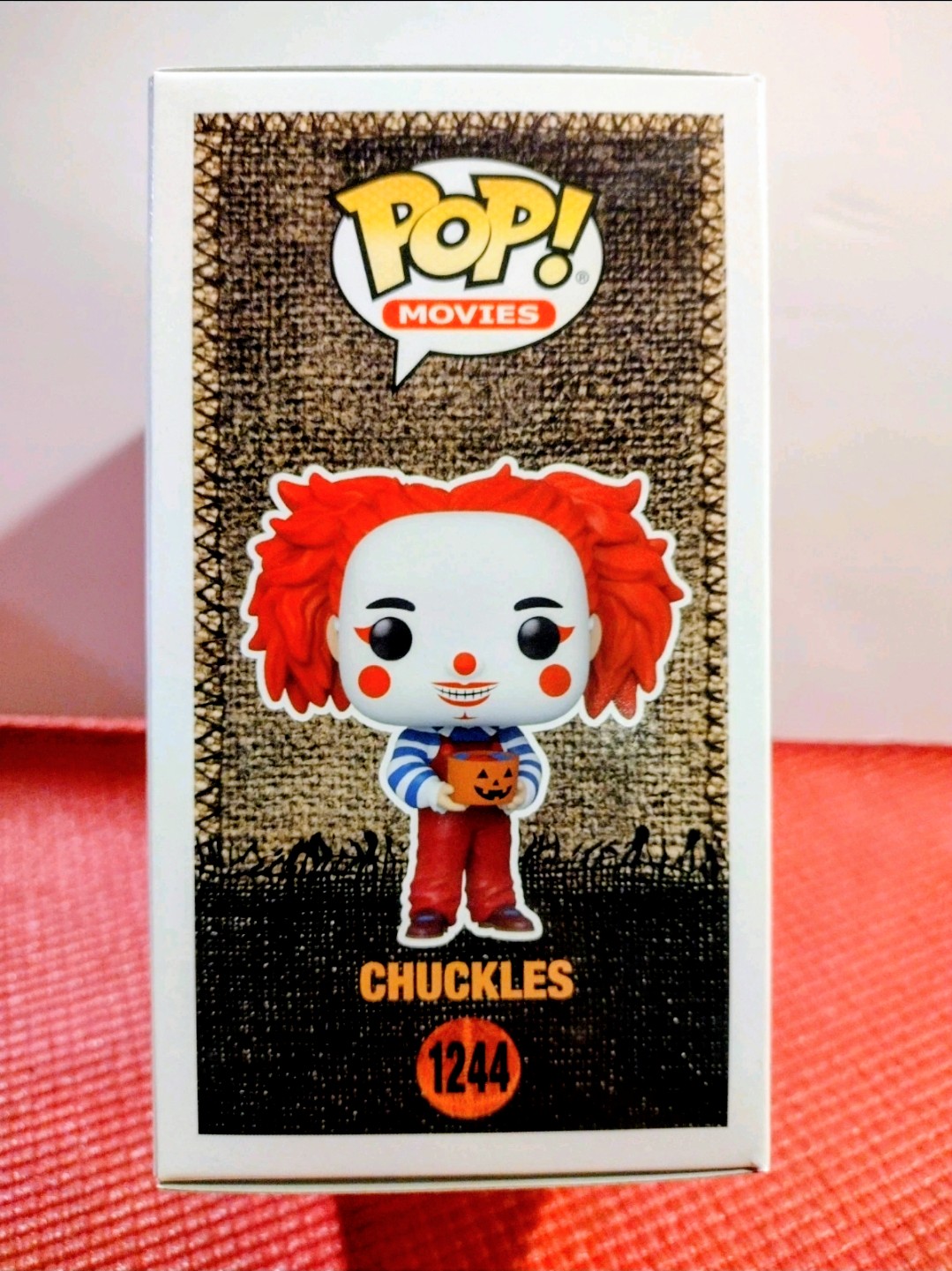 Chuckles Funko Pop! figure in boxed packaging, red wig and jack-o-lantern character art