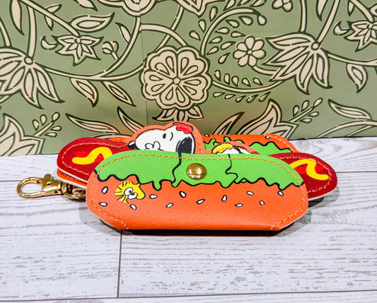 Hot dog keychain holder with orange base, multicolor filling, and gold keyring