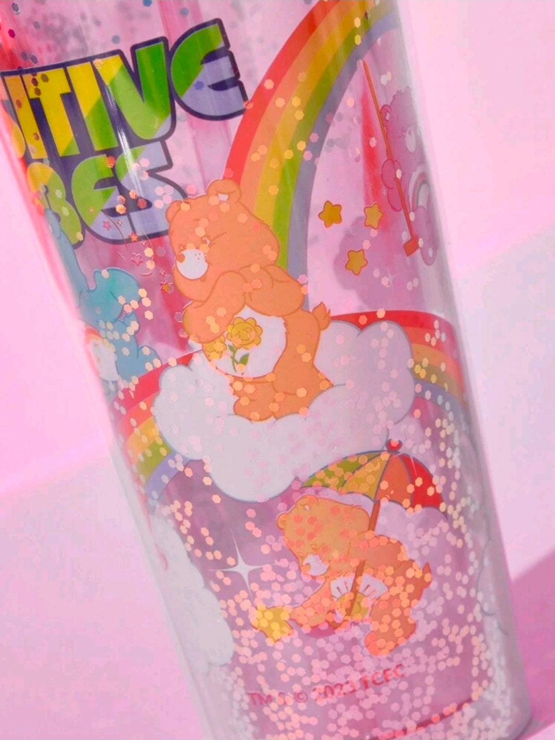 Glitter tumbler cup with straw, Care Bears positive vibe design.