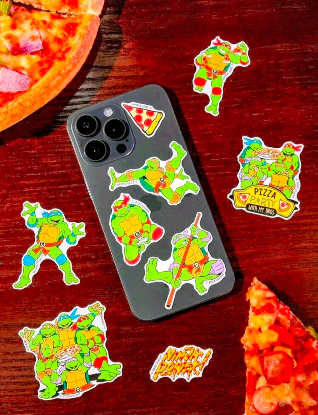 TMNT sticker pack set with turtle and pizza decals displayed on a phone case