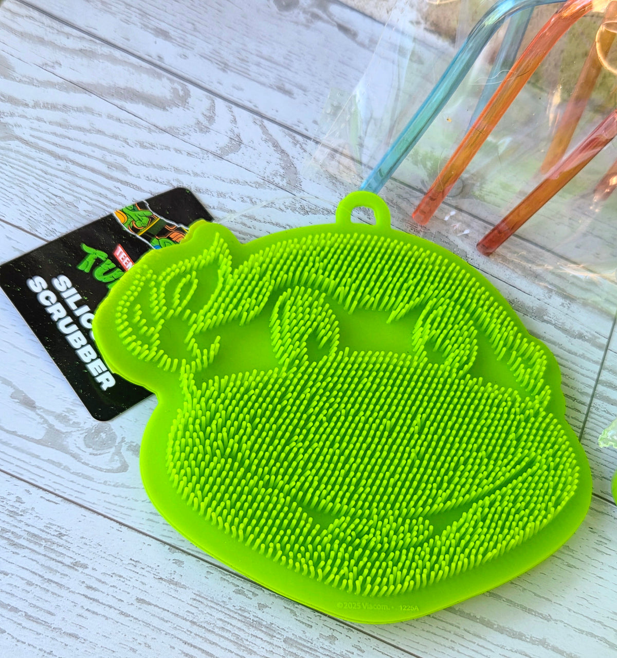 Neon green Turtle logo silicone scrubber with textured bristles