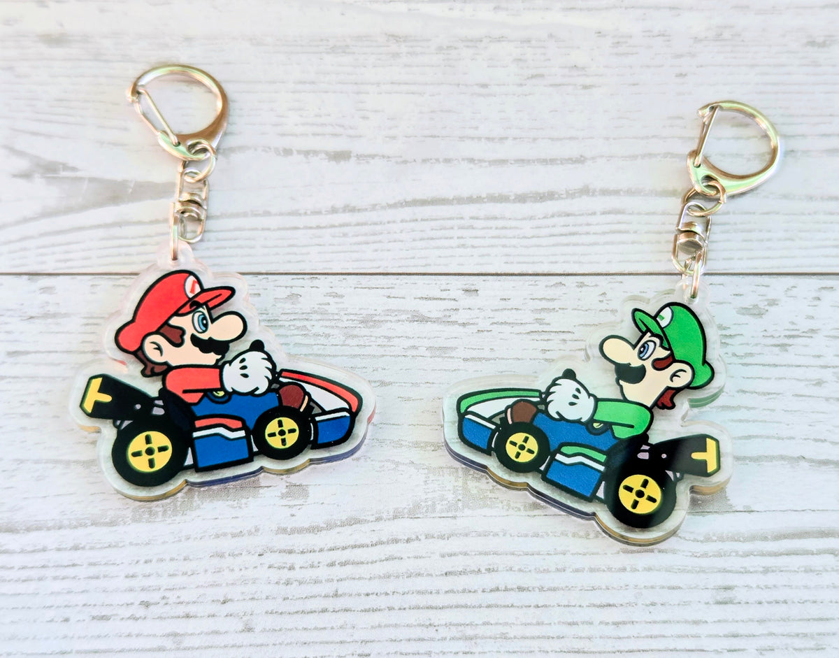 Acrylic keychain set with Mario and Luigi racing karts, gold rings