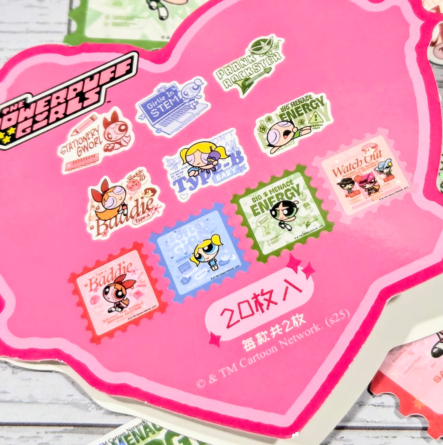 Holographic glitter sticker sheet with multiple colorful cartoon stickers on pink heart