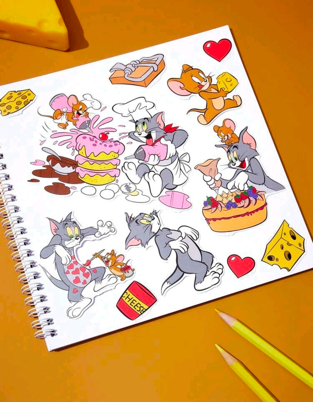 Tom and Jerry vinyl sticker sheet with hearts, cakes, and character faces
