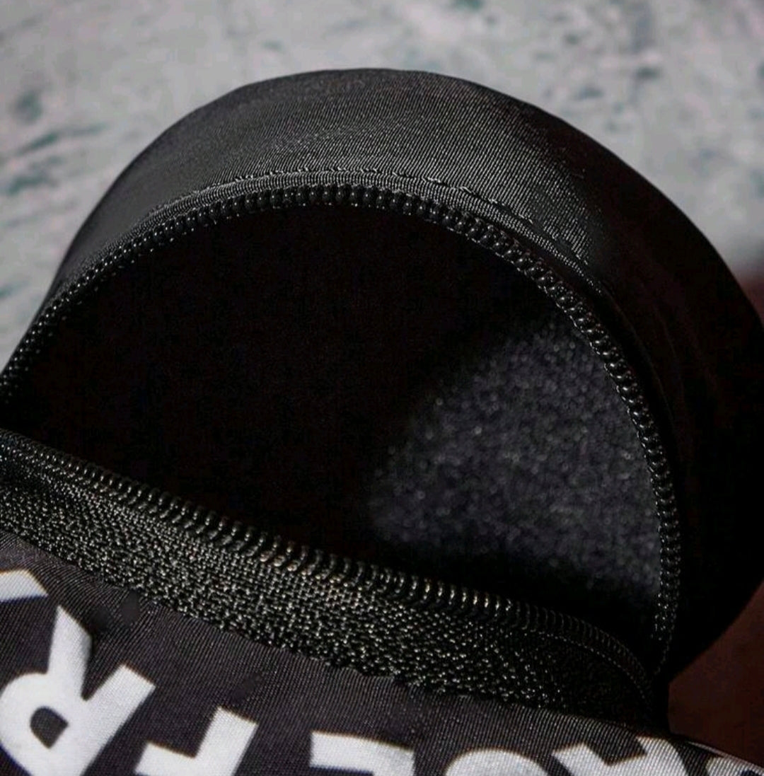 Black zipper opening on round coin pouch with stitched edge