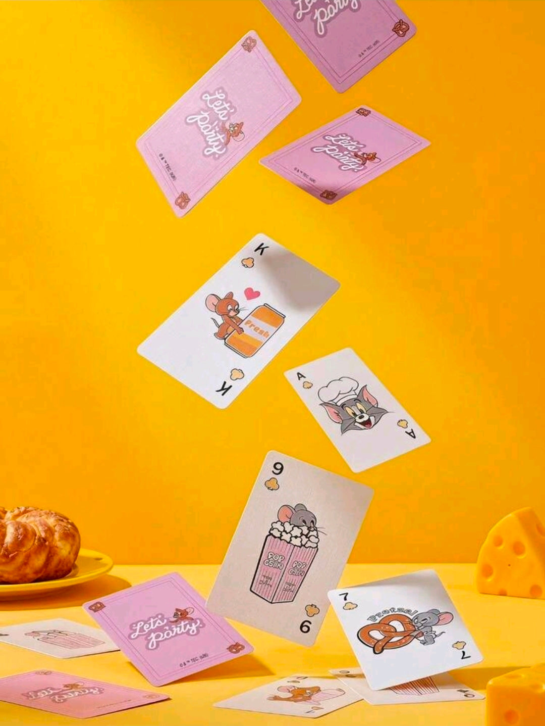 Tom & Jerry playing cards spread out with purple deck and character face cards