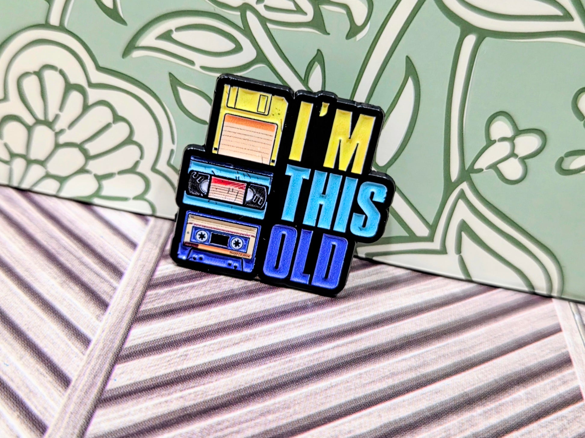 Enamel pin with cassette design and text 'I'm This Old'