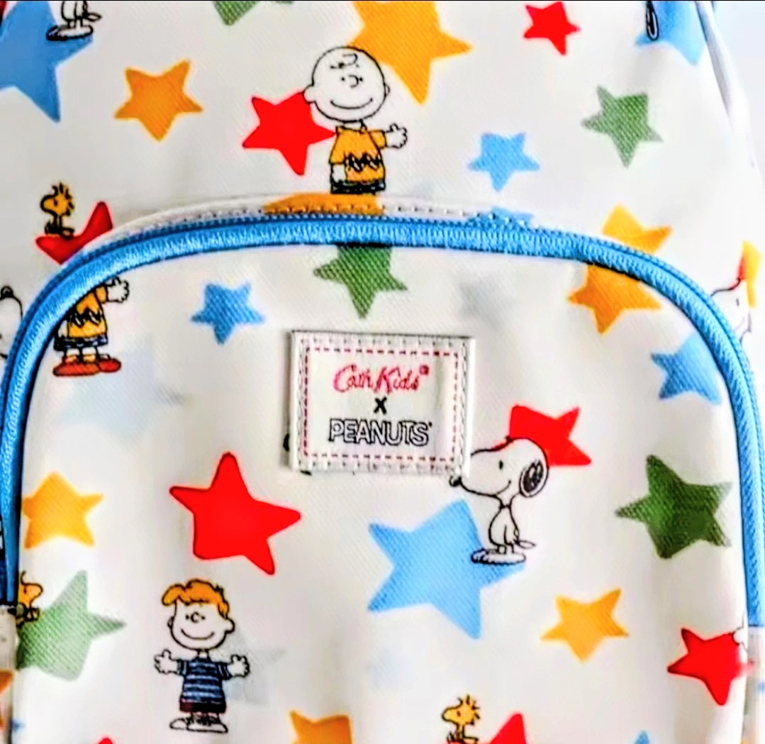 Kids mini backpack close-up, star print with Peanuts characters on front patch