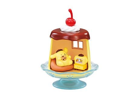 Pompompurin mini figure in bedroom dome, bear resting on orange cushion
