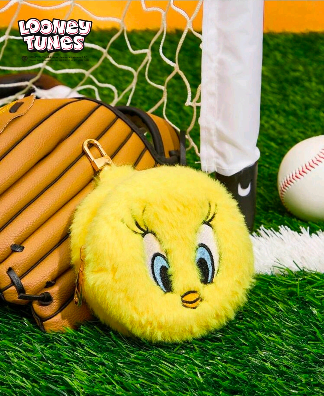 Yellow Tweety plush coin pouch keychain lying down with metal key clip visible