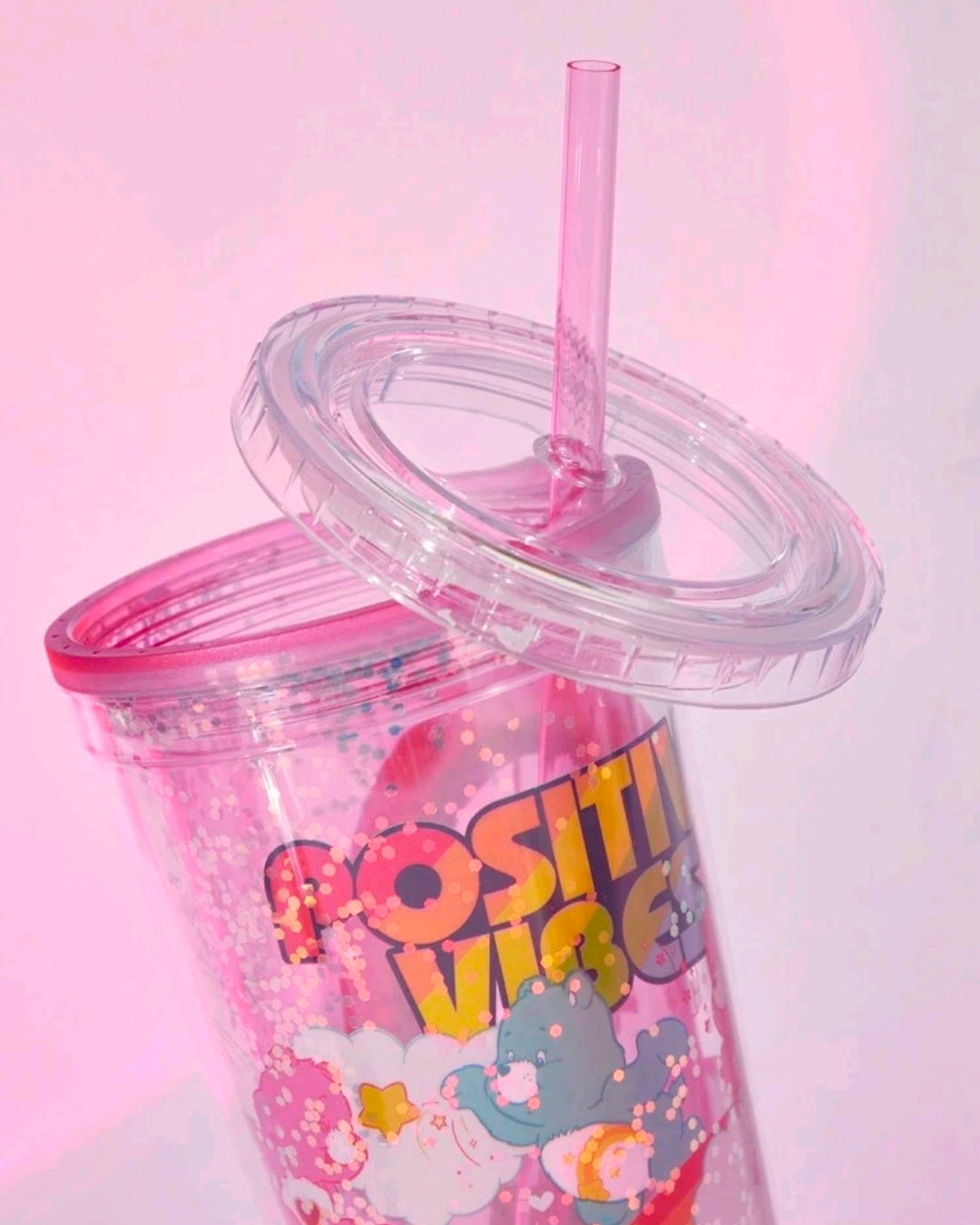 Glitter tumbler cup lid with straw, Care Bears positive vibe artwork.