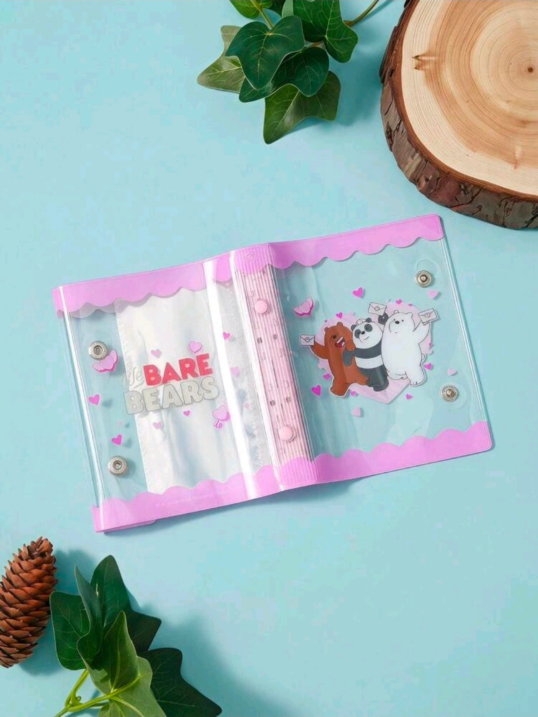 Transparent mini photocard binder opened, pink 6-ring spine with We Bare Bears print.