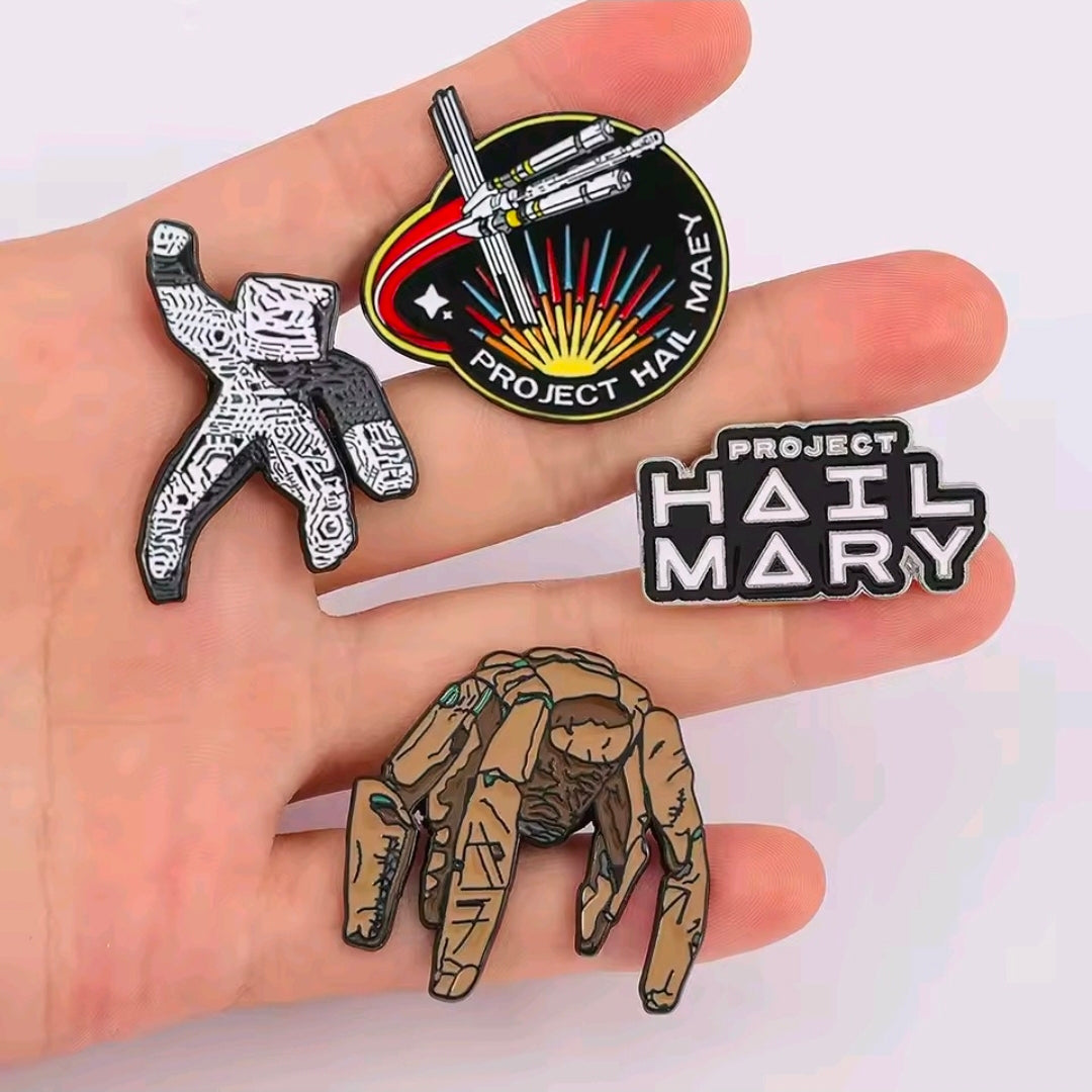4-piece enamel pin set shown in hand: character figures, text logo, and ship emblem