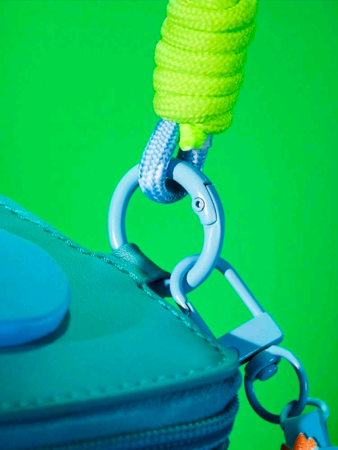 Close-up: teal lanyard cord on blue change bag with metal ring