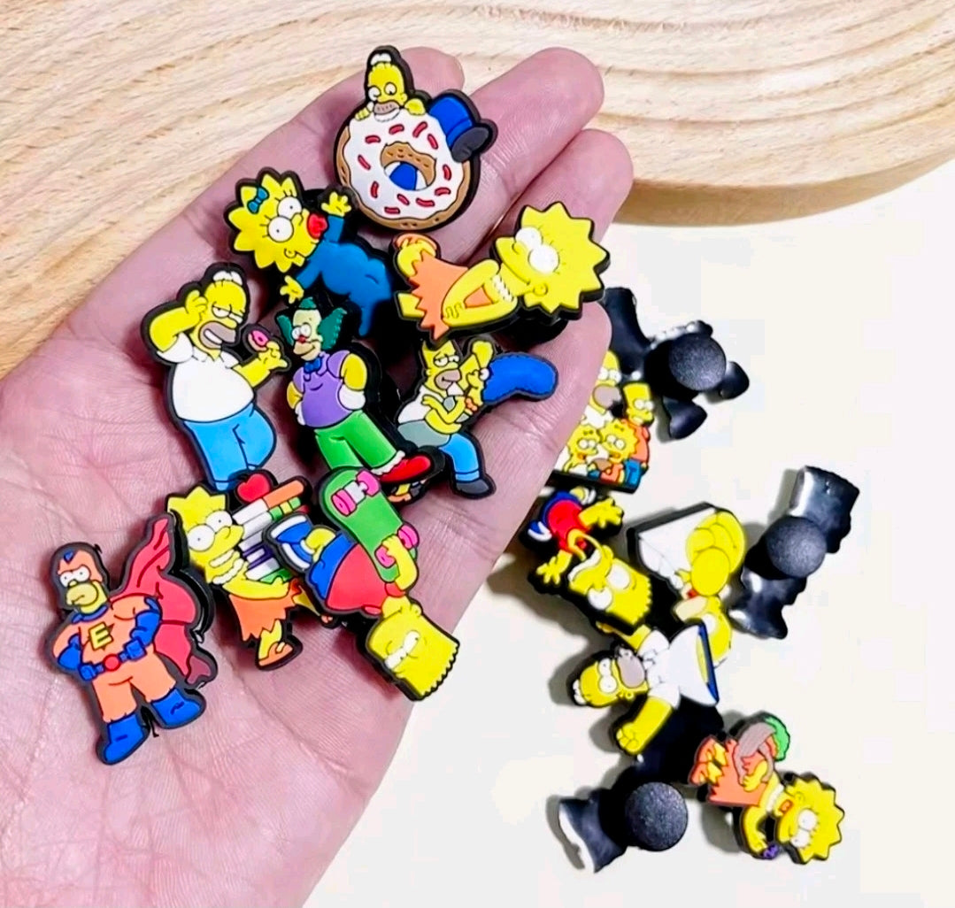Simpsons shoe bag charms pins scattered on an open hand