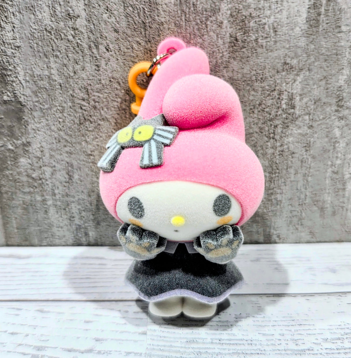Three-quarter view My Melody witch-hat flocked bag clip with orange loop keyring