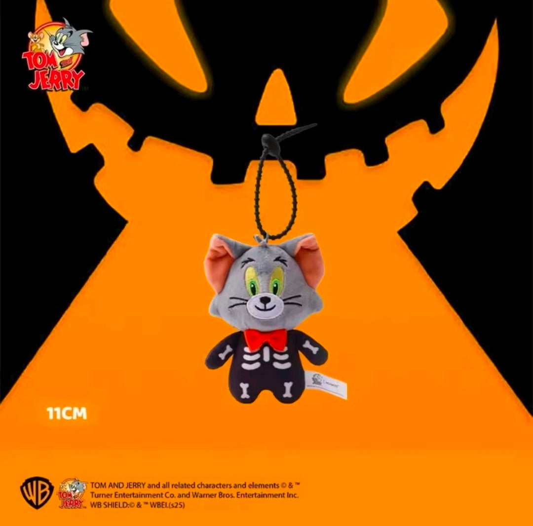 Grey plush cat skeleton keychain hanging from black loop, green eyes, red bow tie