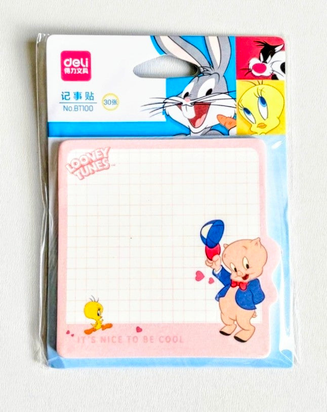Sticky note pad with Porky Pig cartoon holding balloon on grid paper