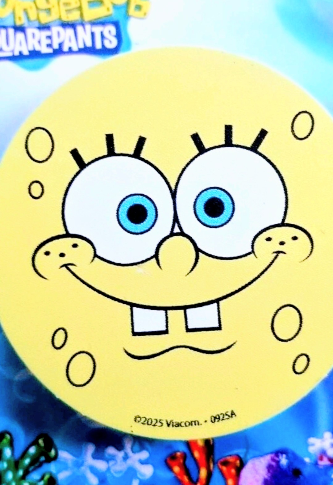 Round SpongeBob SquarePants phone grip with smiling face illustration