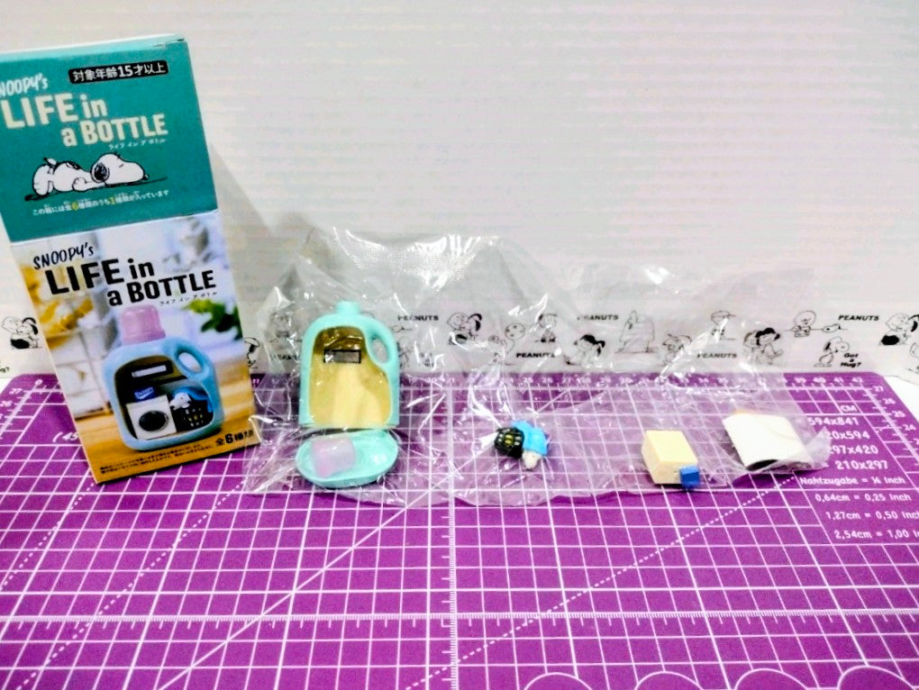 Sealed Snoopy life-in-a-bottle figure set with outer box and small toy bottle parts