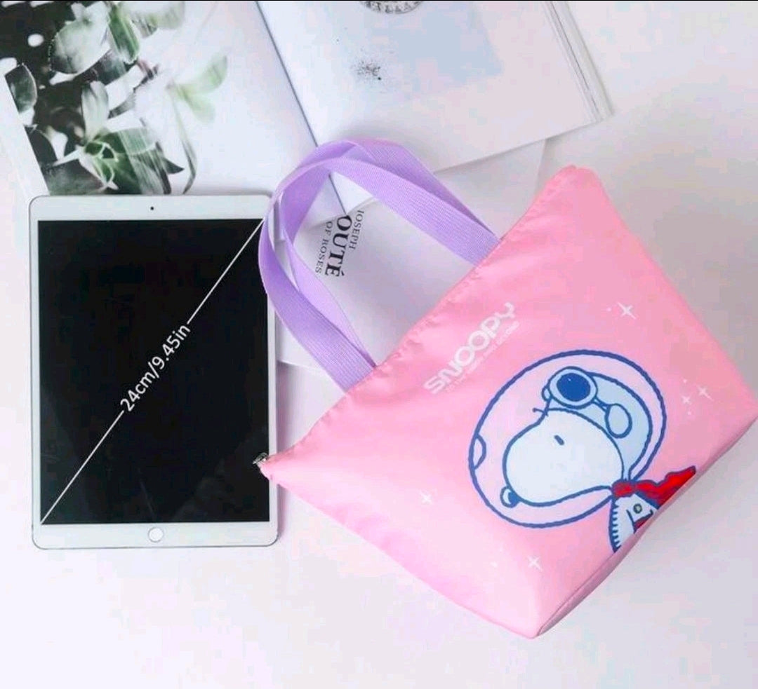 Pink insulated lunch bag with purple handles, blue Snoopy face graphic, and zipper top