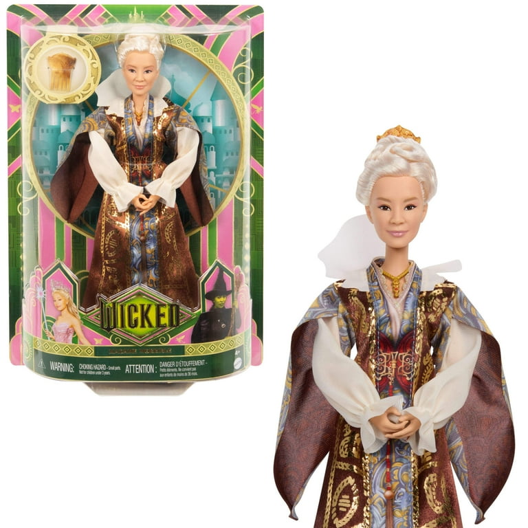 Fashion doll in maroon coat with gold trim and blue patterned vest; white gloves and headpiece.