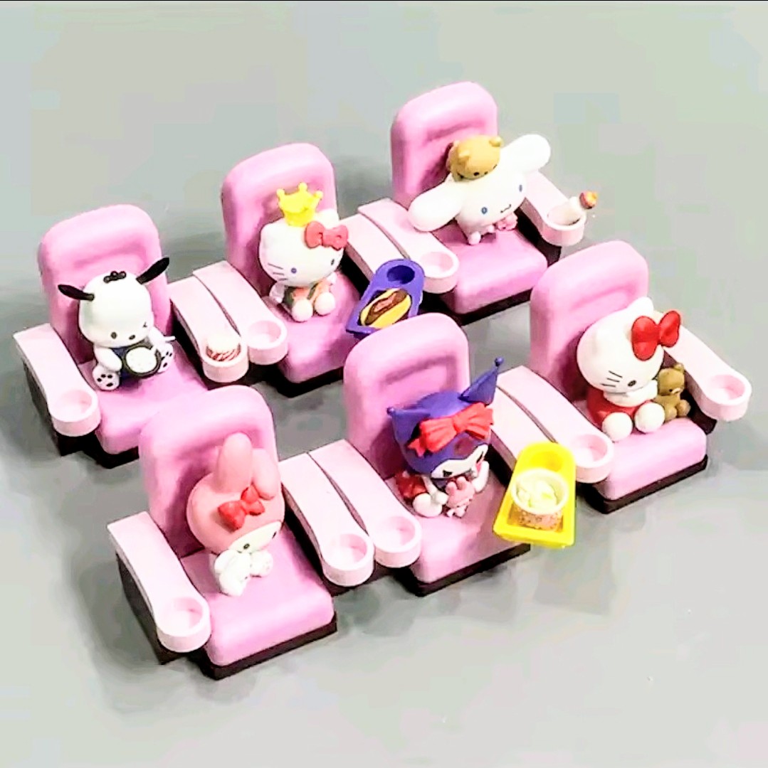 Mini character figures on pink seats with small props and table food items