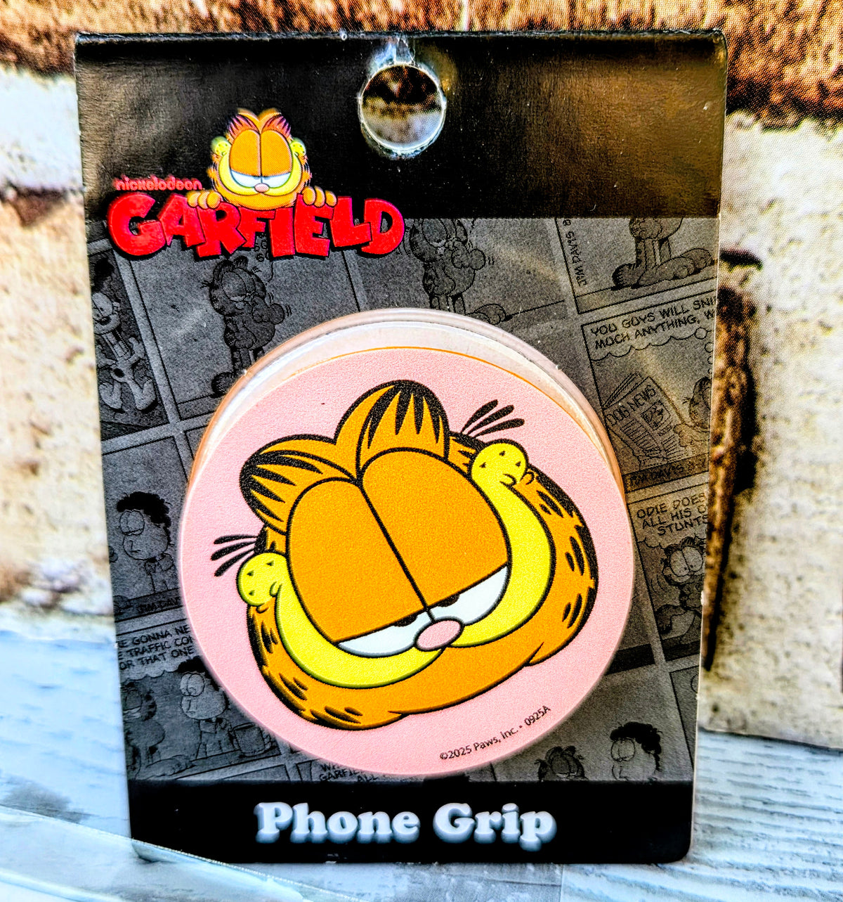 Garfield phone grip accessory in a box with character face on pink circle