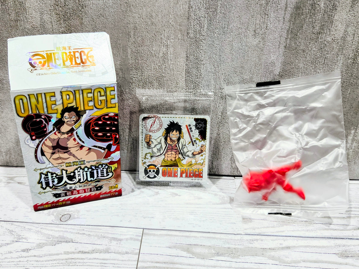 Sealed bag with small red collectible figure, One Piece character card, and product box